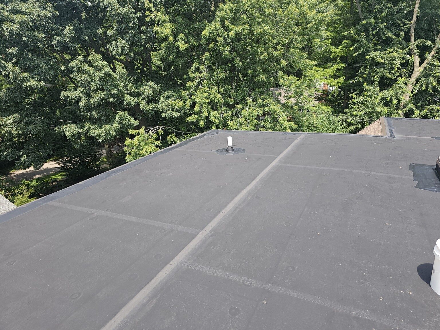 Completed roof membrane around vents and roof edges