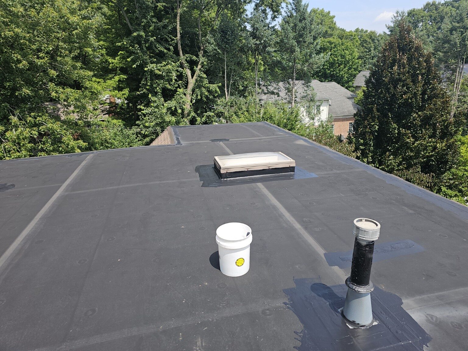 Finished low-slope roof around skylight and penetrations