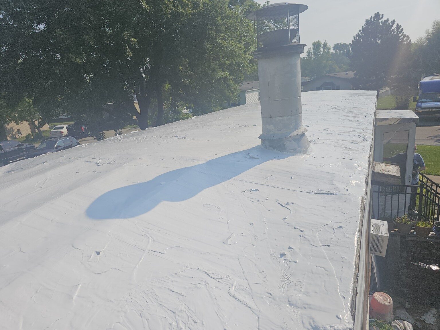 Flat roof before replacement showing the existing white roof surface