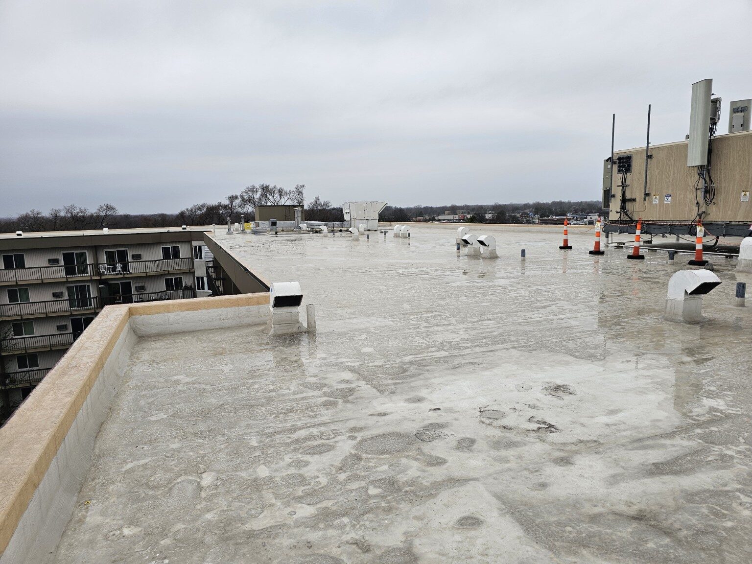 Wide view of a completed low-slope commercial roofing system