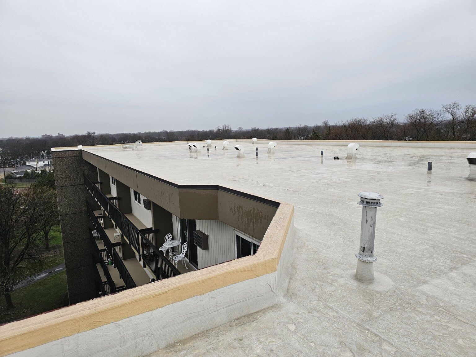 Finished commercial roof membrane along a multi-story building