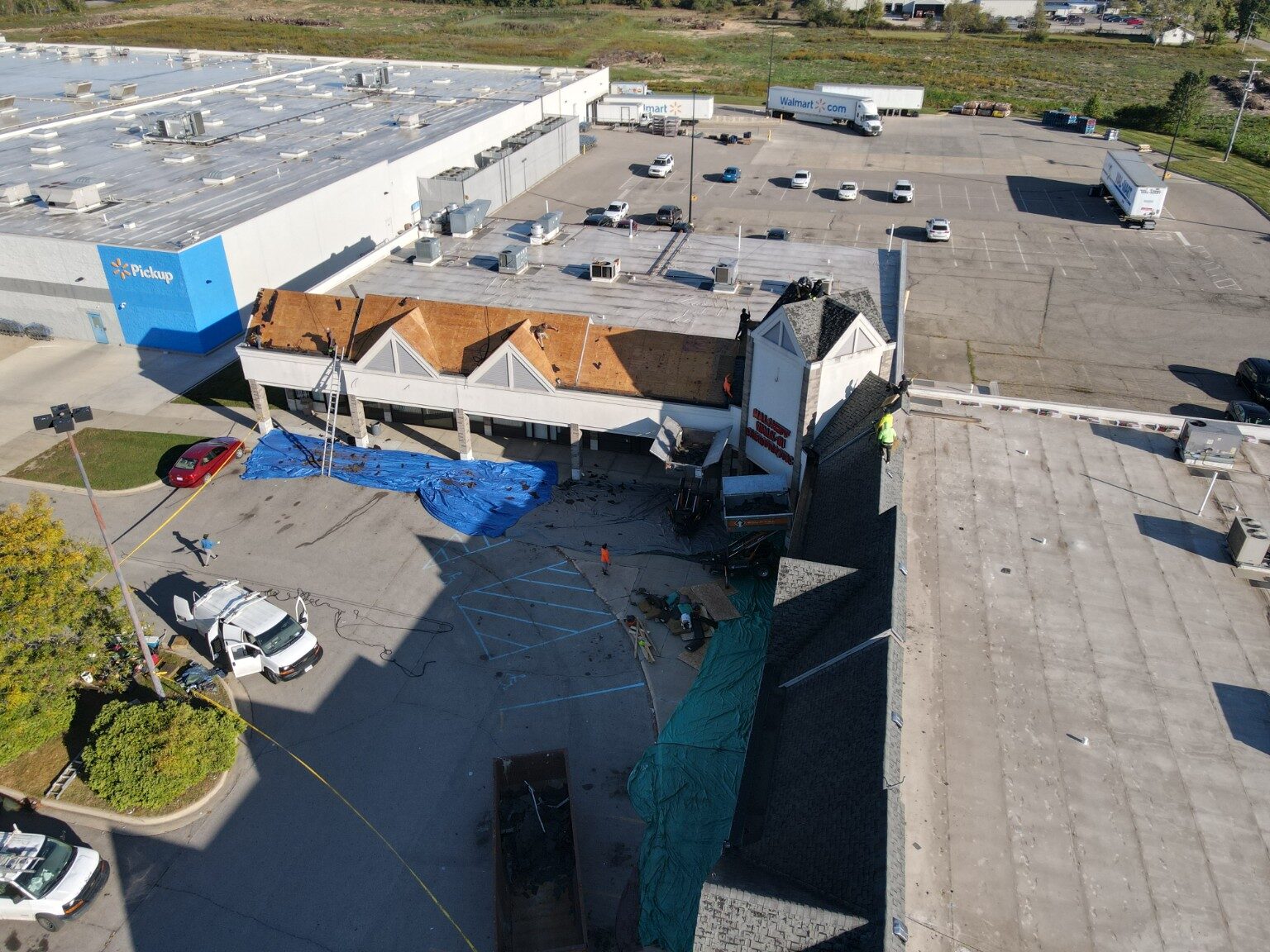 Drone view of a large commercial property during roof replacement