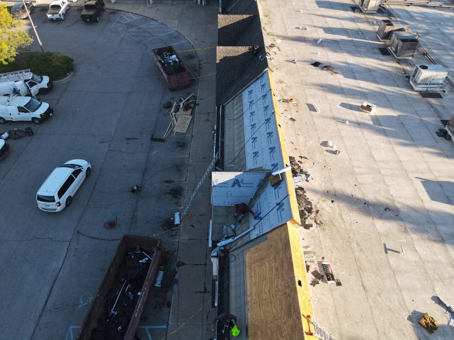 Aerial detail of commercial roof construction beside an active property