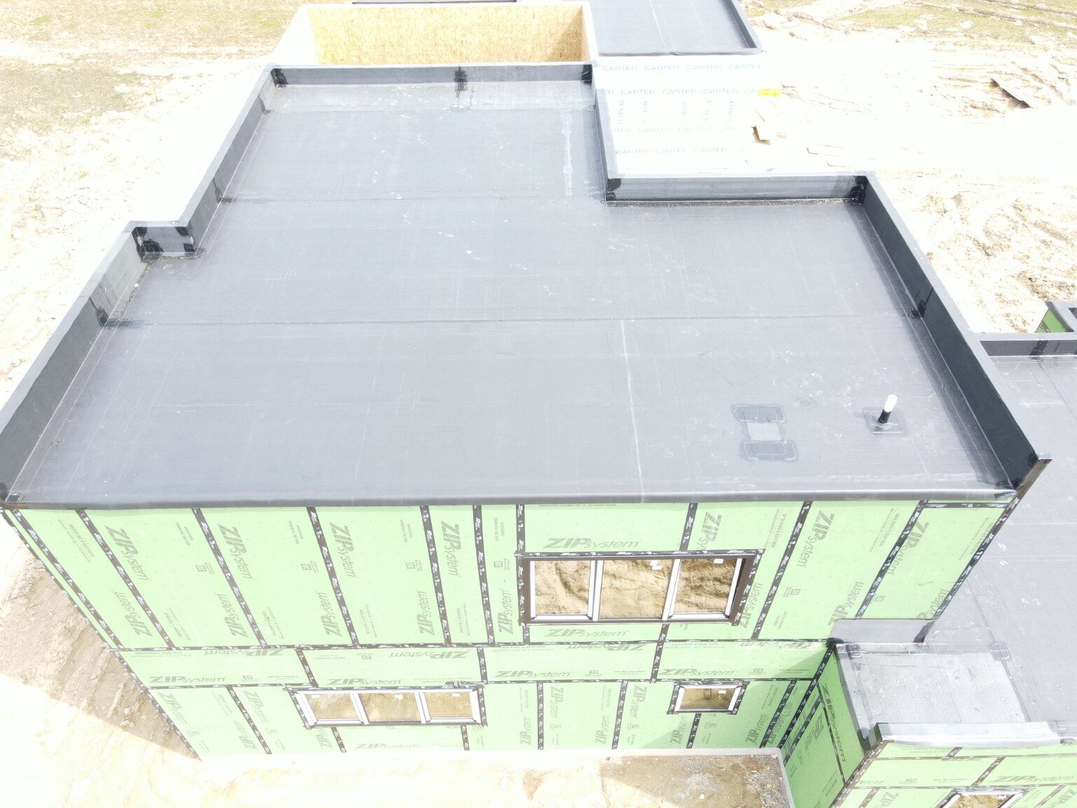 EPDM roof installation around an enclosed structure