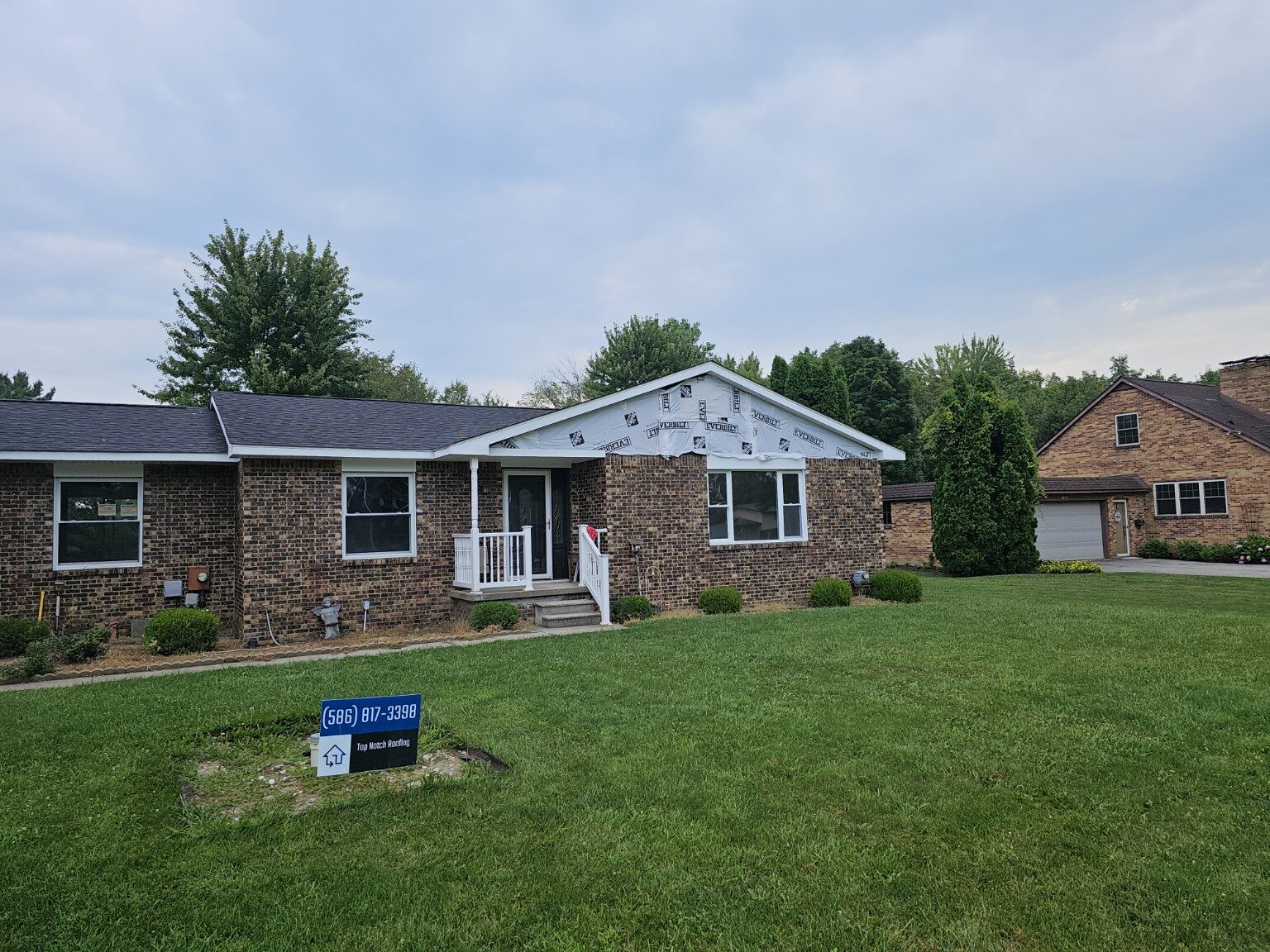 Exterior renovation with house wrap and Hardie board installation underway